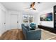 Bright living room with wood flooring, view to front yard and sleek entertainment center at 1851 Oklahoma Ne Ave, St Petersburg, FL 33703
