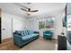 Comfortable living room with wood floors, light-blue sofa and view to the neighborhood at 1851 Oklahoma Ne Ave, St Petersburg, FL 33703