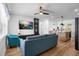 Cozy living room featuring light-blue sofa, wooden floors, and an entertainment center at 1851 Oklahoma Ne Ave, St Petersburg, FL 33703