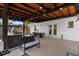 Covered patio with a ceiling fan, bar and seating area, along with an outdoor dining table at 1851 Oklahoma Ne Ave, St Petersburg, FL 33703