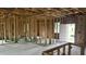 Unfinished interior featuring exposed wooden framing, a doorway, and rough flooring at 18581 Lake Worth Blvd, Port Charlotte, FL 33948