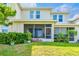 Backyard featuring a screened-in porch and privacy hedges at 1962 Marlington Way, Clearwater, FL 33763