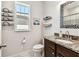 Bathroom featuring stylish vanity, granite counters, ample light from the bright window and marble floors at 1962 Marlington Way, Clearwater, FL 33763