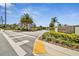 Inviting entrance to Montclair Lake, featuring manicured landscaping, a brick-paved crosswalk, and clear signage at 1962 Marlington Way, Clearwater, FL 33763
