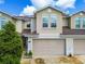 Charming townhome featuring a two-car garage, neutral stucco facade, and well-maintained landscaping at 1962 Marlington Way, Clearwater, FL 33763