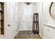 Inviting home foyer featuring a rug, coat rack, and storage at 1962 Marlington Way, Clearwater, FL 33763