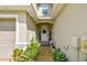 Charming front entryway featuring decorative plants and a welcoming front door at 1962 Marlington Way, Clearwater, FL 33763