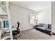 Well-lit home office with a sofa and shelving, perfect for a productive workspace at 1962 Marlington Way, Clearwater, FL 33763
