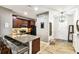 Well-equipped kitchen showcasing a breakfast bar, wooden cabinets, and modern appliances at 1962 Marlington Way, Clearwater, FL 33763