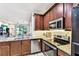 Modern kitchen with granite countertops, stainless steel appliances, and ample cabinet space at 1962 Marlington Way, Clearwater, FL 33763