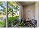 Screened-in lanai with chairs and lake views, perfect for relaxing or dining at 1962 Marlington Way, Clearwater, FL 33763