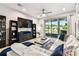 Cozy living room with large windows overlooking the water and entertainment center at 1962 Marlington Way, Clearwater, FL 33763