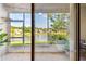 Enclosed patio with a view of the backyard and lake at 1962 Marlington Way, Clearwater, FL 33763