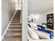 Carpeted staircase leading to the second floor and view of the living room at 1962 Marlington Way, Clearwater, FL 33763