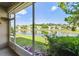 Screened in porch view of pond and manicured lawns of neighboring houses at 1962 Marlington Way, Clearwater, FL 33763