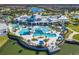 Stunning aerial view of the community pool and clubhouse, highlighting amenities and the beautiful surroundings at 19652 Ship Wheel Way, Land O Lakes, FL 34638