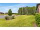 Spacious backyard with expansive lawn, lake view and mature trees at 19652 Ship Wheel Way, Land O Lakes, FL 34638
