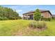 Spacious backyard with a well-maintained lawn and a covered patio at 19652 Ship Wheel Way, Land O Lakes, FL 34638