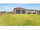 Spacious backyard featuring a screened-in patio and lush green lawn perfect for outdoor enjoyment at 19652 Ship Wheel Way, Land O Lakes, FL 34638