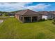 Spacious backyard with a screened-in patio and lush green lawn at 19652 Ship Wheel Way, Land O Lakes, FL 34638