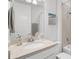 Bathroom with a quartz countertop, decorative lighting, and tiled shower/tub surround at 19652 Ship Wheel Way, Land O Lakes, FL 34638