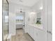 Elegant bathroom with double vanity, neutral tones, and a glass-enclosed shower, offering a spa-like experience at 19652 Ship Wheel Way, Land O Lakes, FL 34638