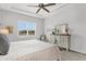 Bright bedroom featuring a ceiling fan, dresser, and window with an attractive view at 19652 Ship Wheel Way, Land O Lakes, FL 34638