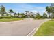 Community entrance with a modern gatehouse and lush landscaping for a welcoming approach at 19652 Ship Wheel Way, Land O Lakes, FL 34638