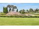 Attractive community entrance featuring lush landscaping and a rock waterfall feature at 19652 Ship Wheel Way, Land O Lakes, FL 34638