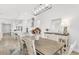 Bright dining room with a wooden table, white chairs, and modern lighting at 19652 Ship Wheel Way, Land O Lakes, FL 34638