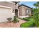 Beautiful exterior view of home with manicured landscaping and brick walkway at 19652 Ship Wheel Way, Land O Lakes, FL 34638
