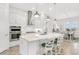 Bright kitchen featuring a large island with seating, white cabinets, and stainless steel appliances at 19652 Ship Wheel Way, Land O Lakes, FL 34638
