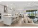 Open-concept kitchen with a large island, white cabinetry, and modern stainless steel appliances at 19652 Ship Wheel Way, Land O Lakes, FL 34638