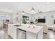 Bright kitchen with a center island, stainless steel appliances, and an open concept living area at 19652 Ship Wheel Way, Land O Lakes, FL 34638