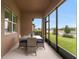 Screened lanai featuring a dining table, chairs, and a beautiful water view at 19652 Ship Wheel Way, Land O Lakes, FL 34638