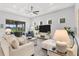 Bright living room with neutral tones, coffered ceiling, and sliding glass doors to the patio at 19652 Ship Wheel Way, Land O Lakes, FL 34638