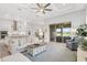 Open-concept living room with sliding glass doors, stylish decor, and access to the kitchen at 19652 Ship Wheel Way, Land O Lakes, FL 34638