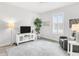 Cozy bonus room with comfortable seating, large windows, and a mounted TV at 19652 Ship Wheel Way, Land O Lakes, FL 34638