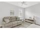 Relaxing living room with a comfortable sofa, natural light, and calming decor at 19652 Ship Wheel Way, Land O Lakes, FL 34638