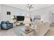Comfortable living room with white sofa and large TV, perfect for relaxation and entertainment at 19652 Ship Wheel Way, Land O Lakes, FL 34638