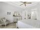 Bright and airy main bedroom with comfortable seating, dresser and ensuite bathroom at 19652 Ship Wheel Way, Land O Lakes, FL 34638