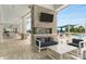An outdoor lounge area with a fireplace, TV, and comfortable seating by the community pool at 19652 Ship Wheel Way, Land O Lakes, FL 34638