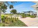 Outdoor seating area with a barbecue, dining tables, and lush landscaping, perfect for entertaining and relaxing at 19652 Ship Wheel Way, Land O Lakes, FL 34638