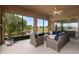 Secluded outdoor patio with lake view, complete with wicker furniture and screened enclosures at 19652 Ship Wheel Way, Land O Lakes, FL 34638
