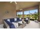Covered outdoor patio featuring comfortable wicker furniture, scenic views, and tranquil ambiance at 19652 Ship Wheel Way, Land O Lakes, FL 34638