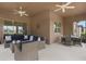 Relaxing outdoor patio with comfortable wicker furniture, ceiling fans, and string lights at 19652 Ship Wheel Way, Land O Lakes, FL 34638