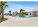 Inviting pool area with palm trees, cabanas, and clear blue waters, perfect for relaxation and recreation at 19652 Ship Wheel Way, Land O Lakes, FL 34638