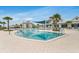 Large community pool with lounge chairs, umbrellas, and beautiful landscaping for relaxation and enjoyment at 19652 Ship Wheel Way, Land O Lakes, FL 34638
