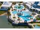 Aerial view of a luxurious resort-style pool with multiple pools, lounge areas, and lush landscaping at 19652 Ship Wheel Way, Land O Lakes, FL 34638