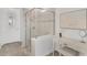 Modern shower with glass enclosure, tiled walls and a decorative accent wall at 19652 Ship Wheel Way, Land O Lakes, FL 34638